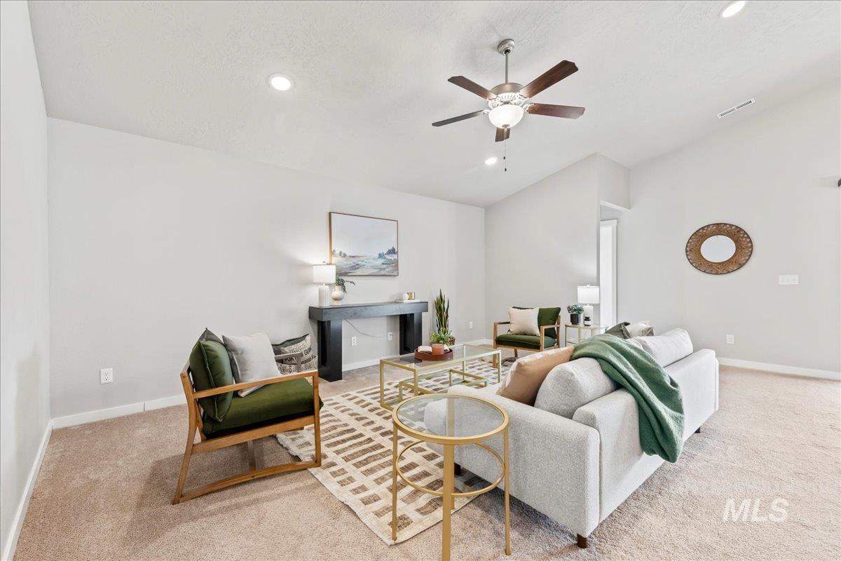 Living room featuring vaulted ceiling, light carpet, a ceiling fan, and recessed lighting