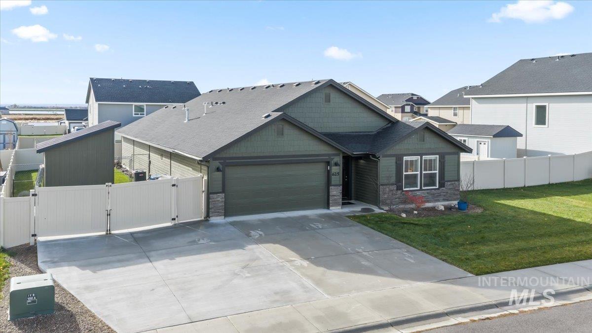 Craftsman house with a gate, driveway, stone siding, and a garage