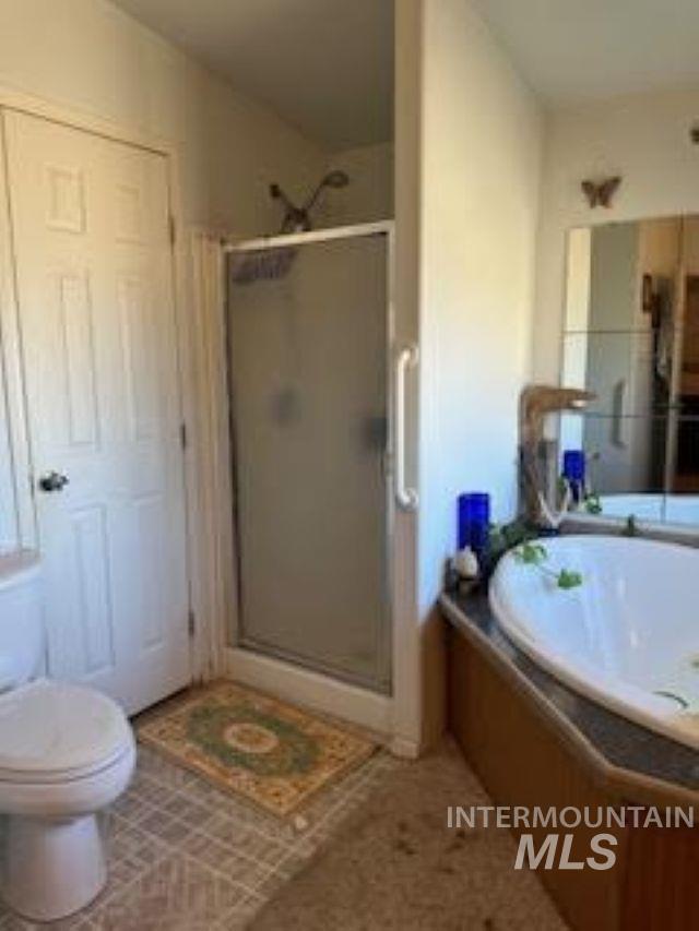 Full bathroom with a stall shower and a bath