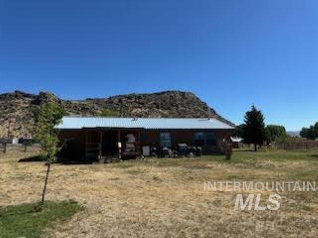 Rear view of house featuring a mountain view
