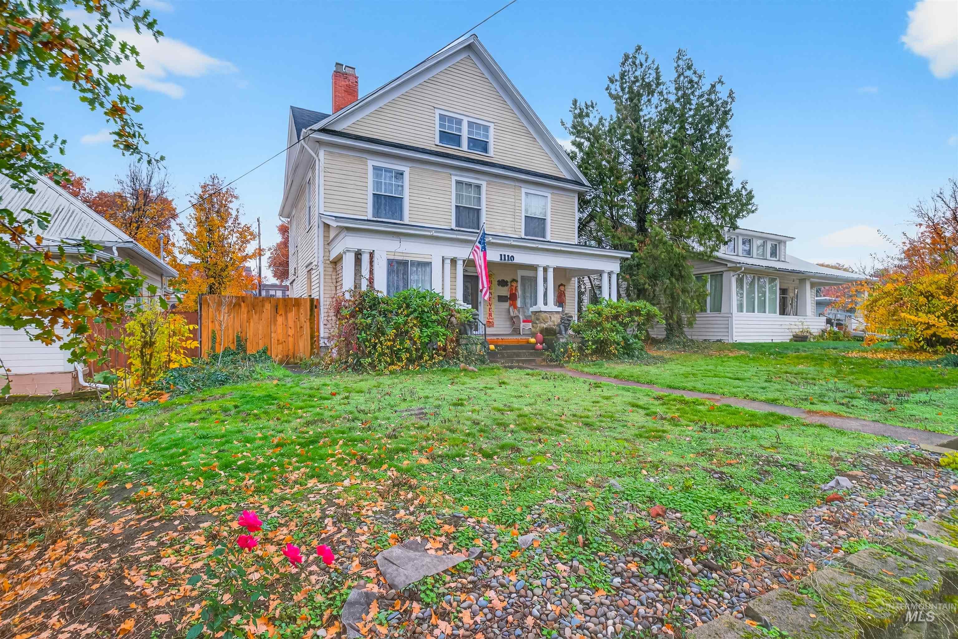 View of front of house featuring a porch and a chimney