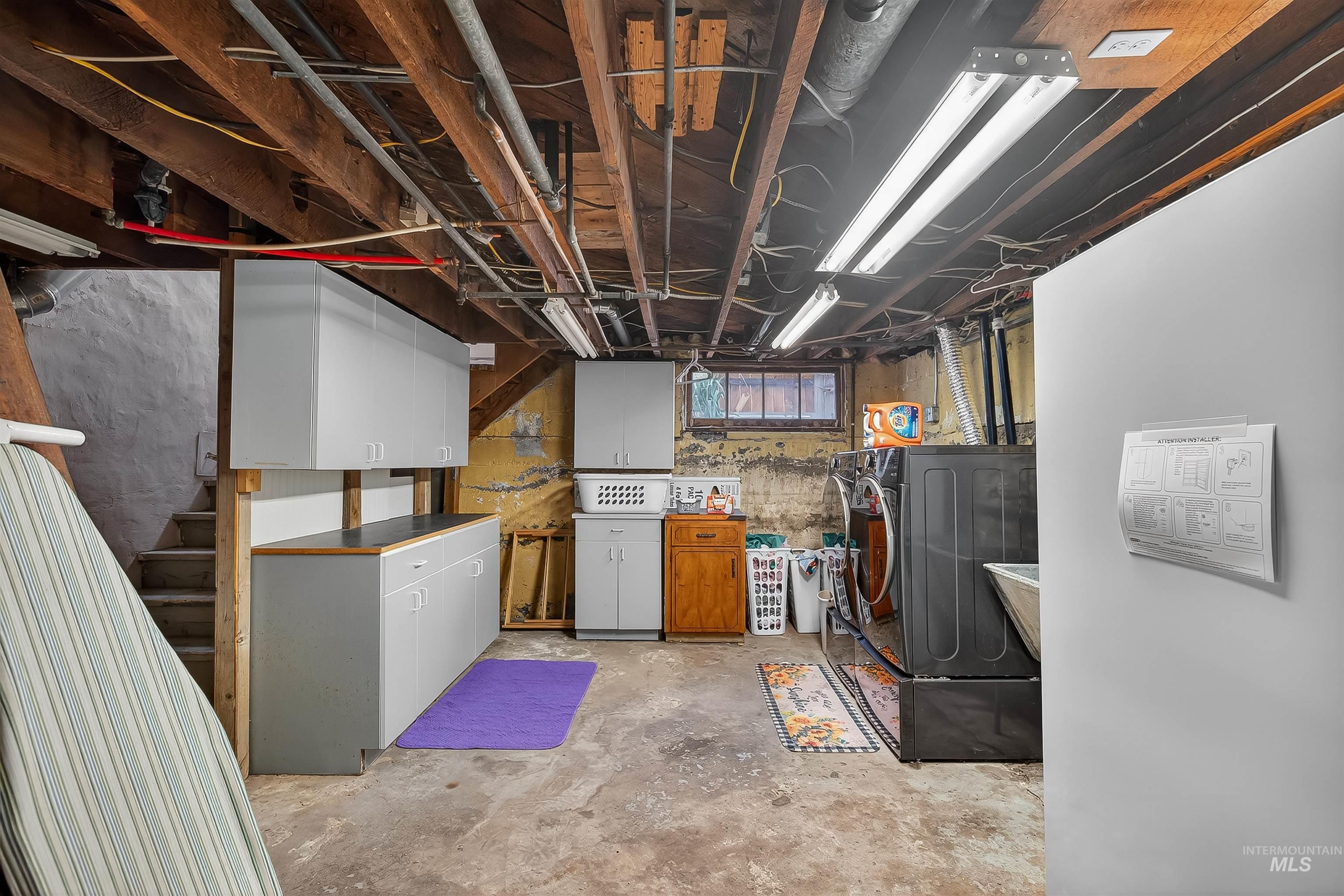 Below grade area with stairway and washer and clothes dryer