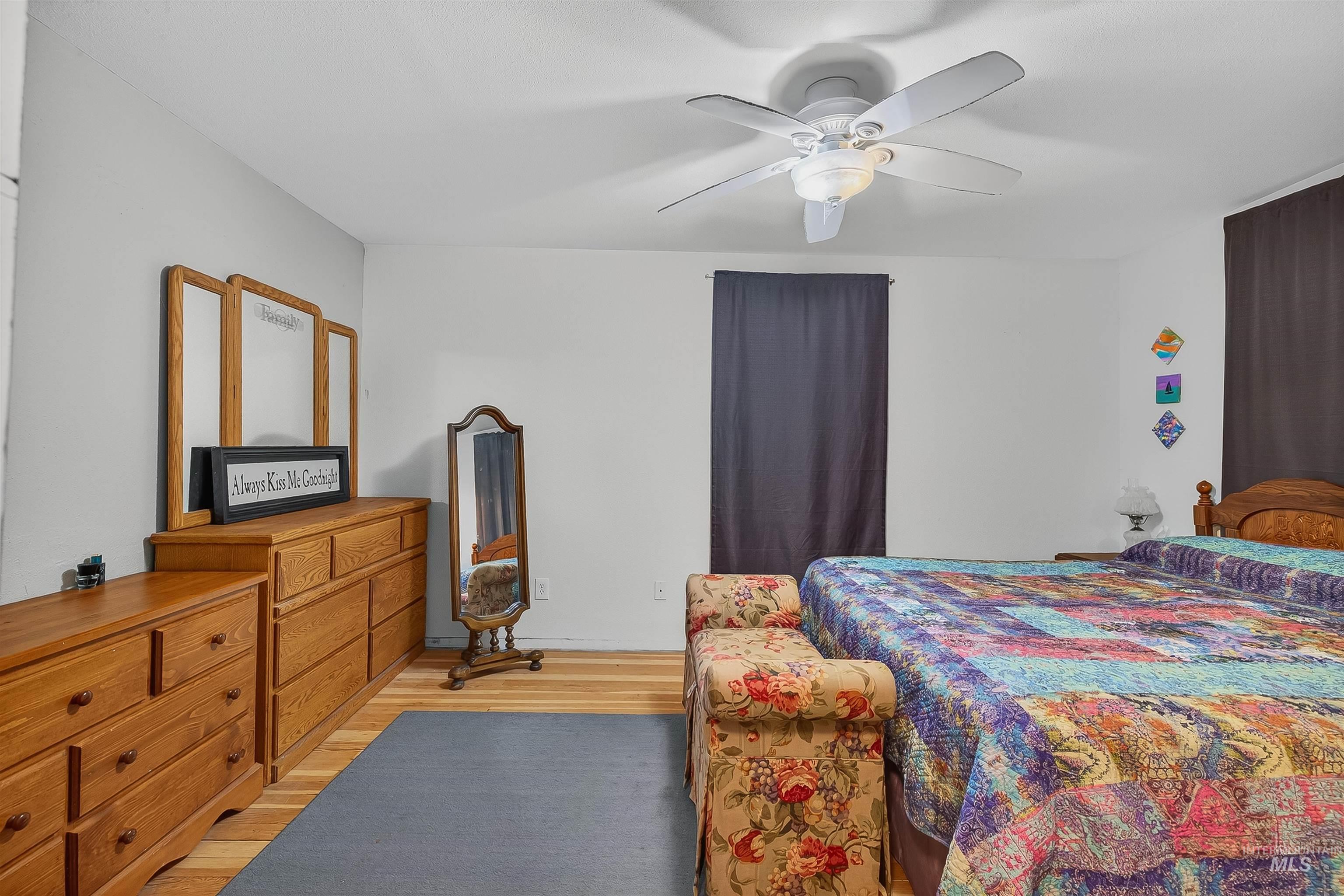Bedroom with light wood-style flooring and a ceiling fan