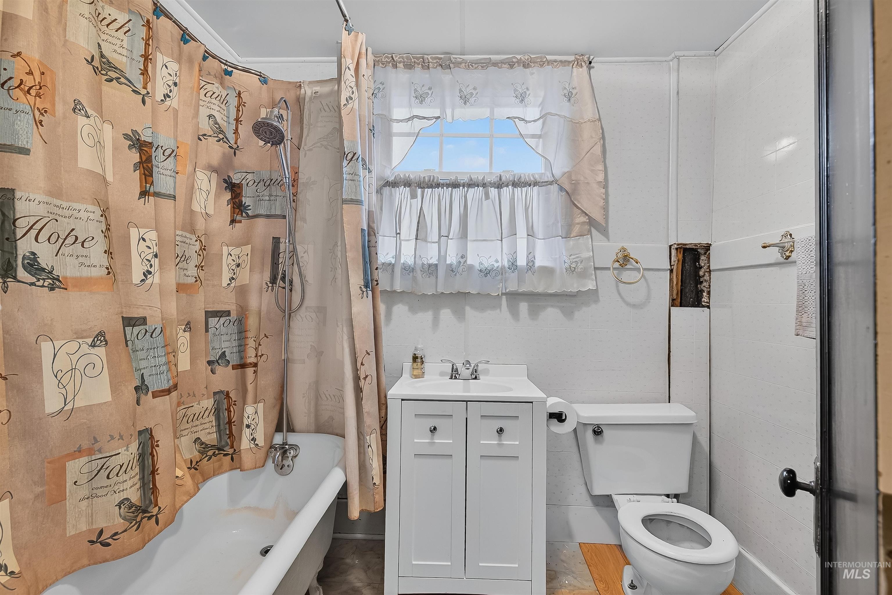 Bathroom with vanity and shower / bath combination with curtain