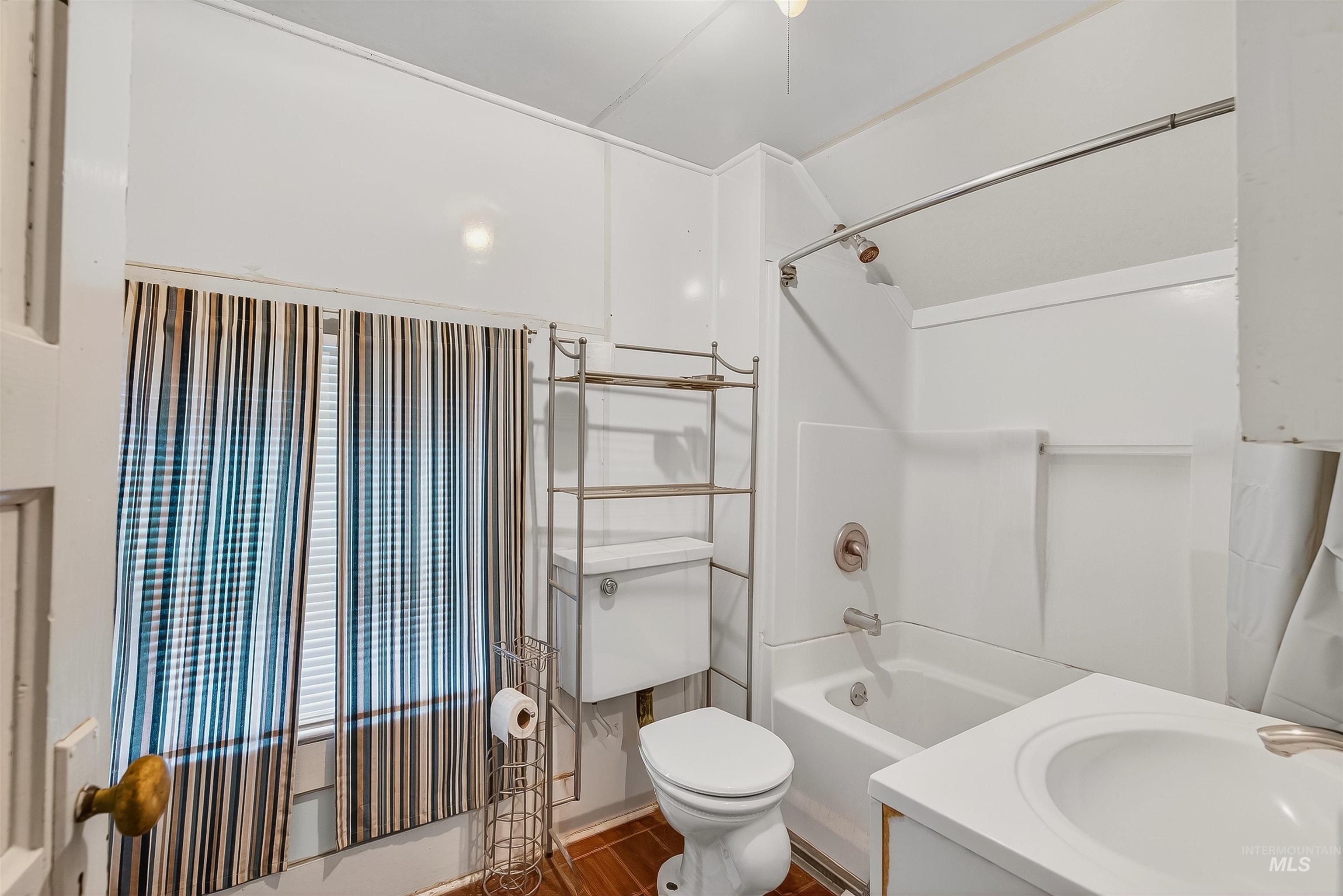 Full bath featuring shower / bathtub combination, vanity, and dark wood finished floors