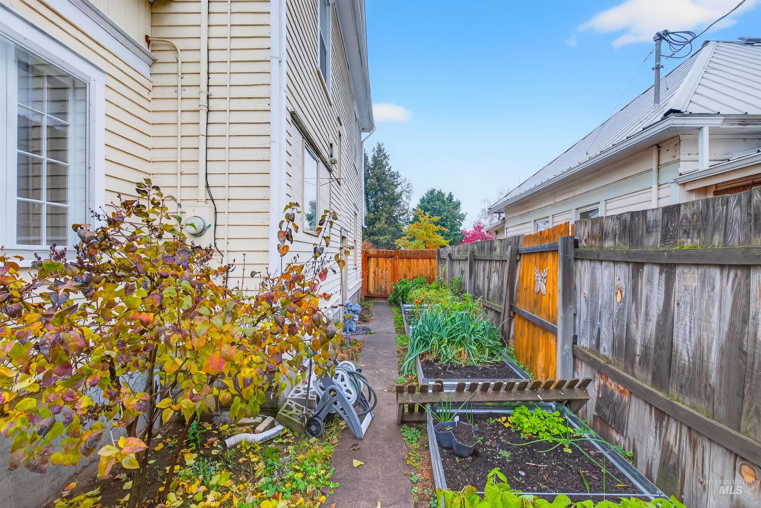 Fenced backyard with a garden