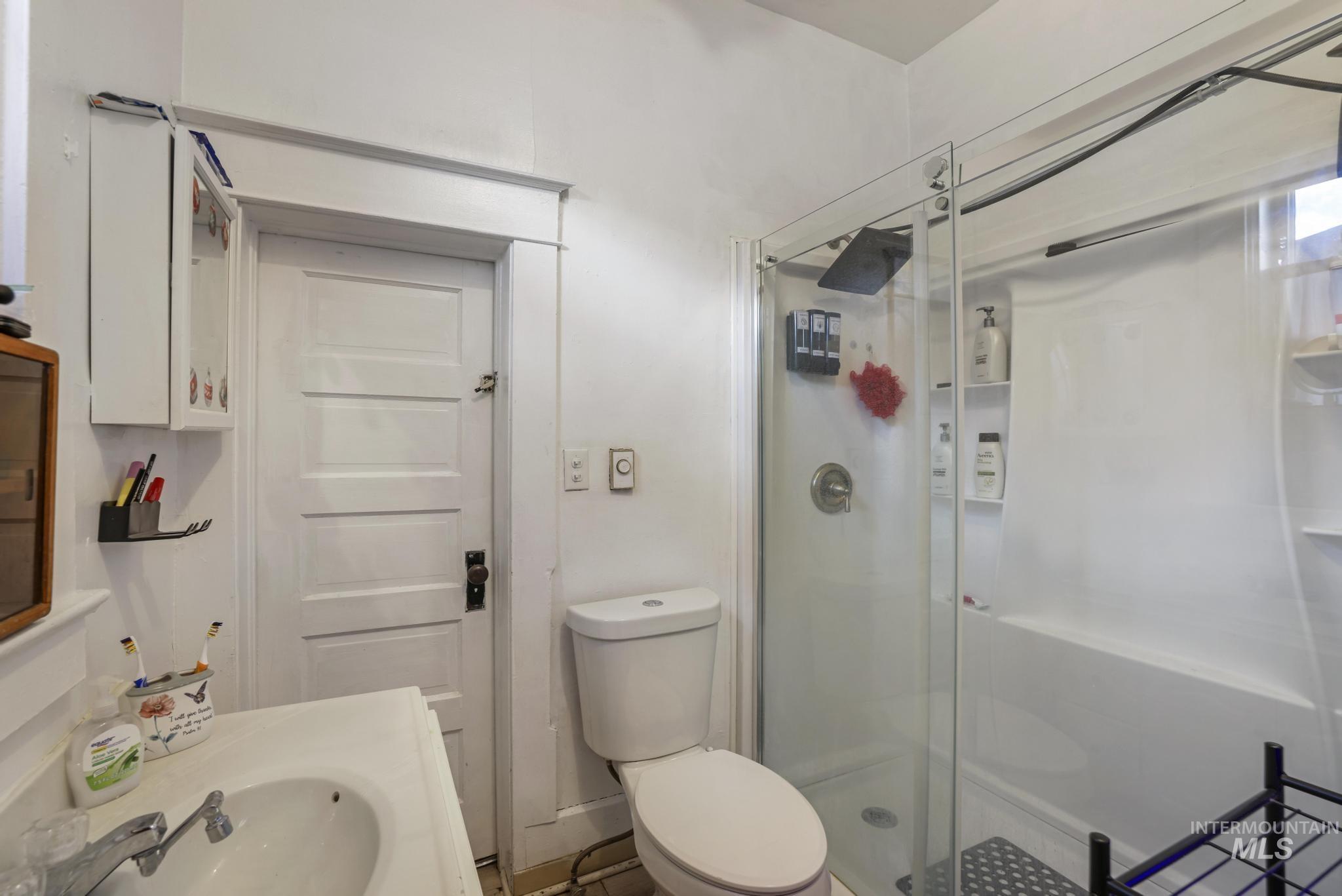 Bathroom with a shower stall and vanity