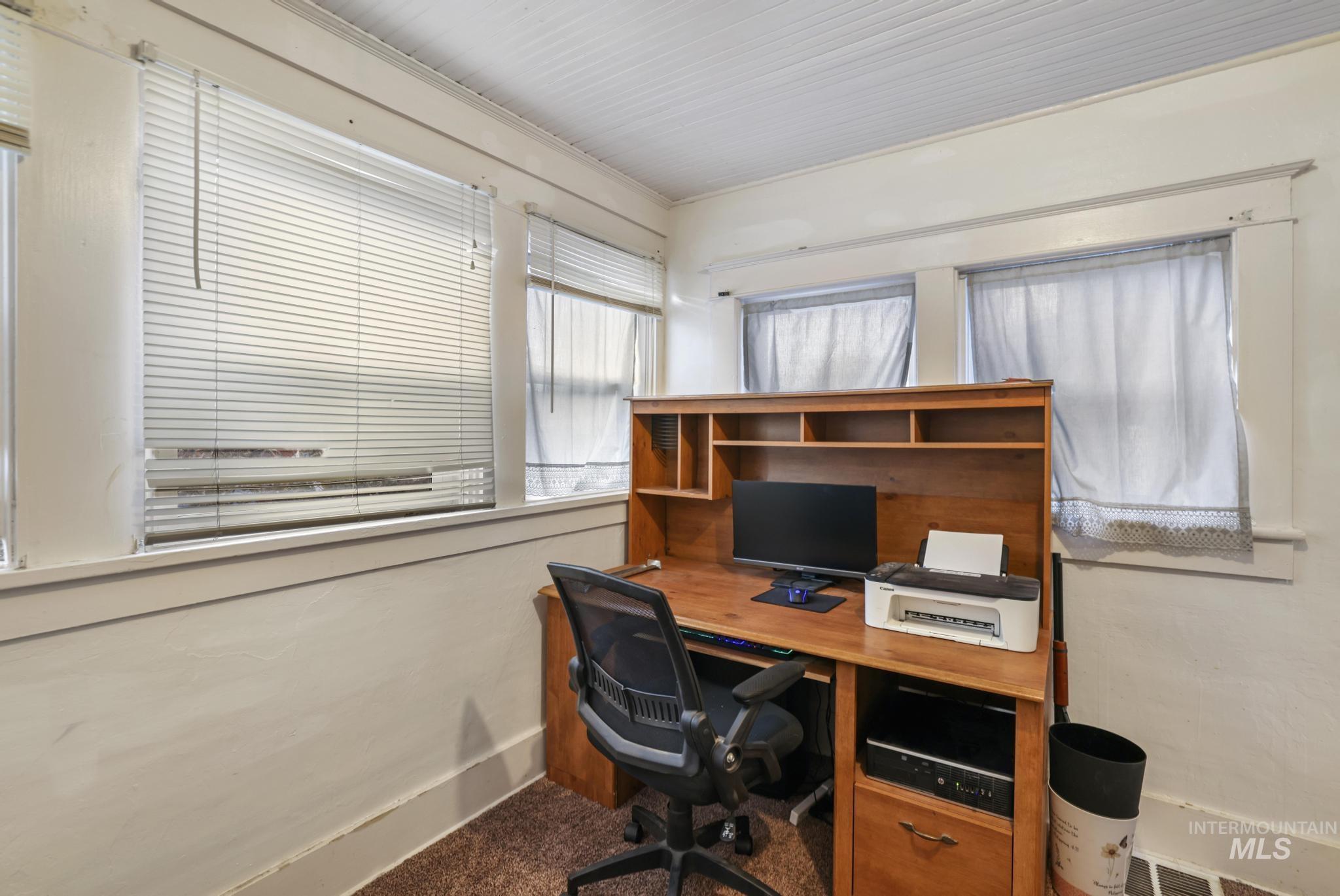 Office space with carpet and baseboards