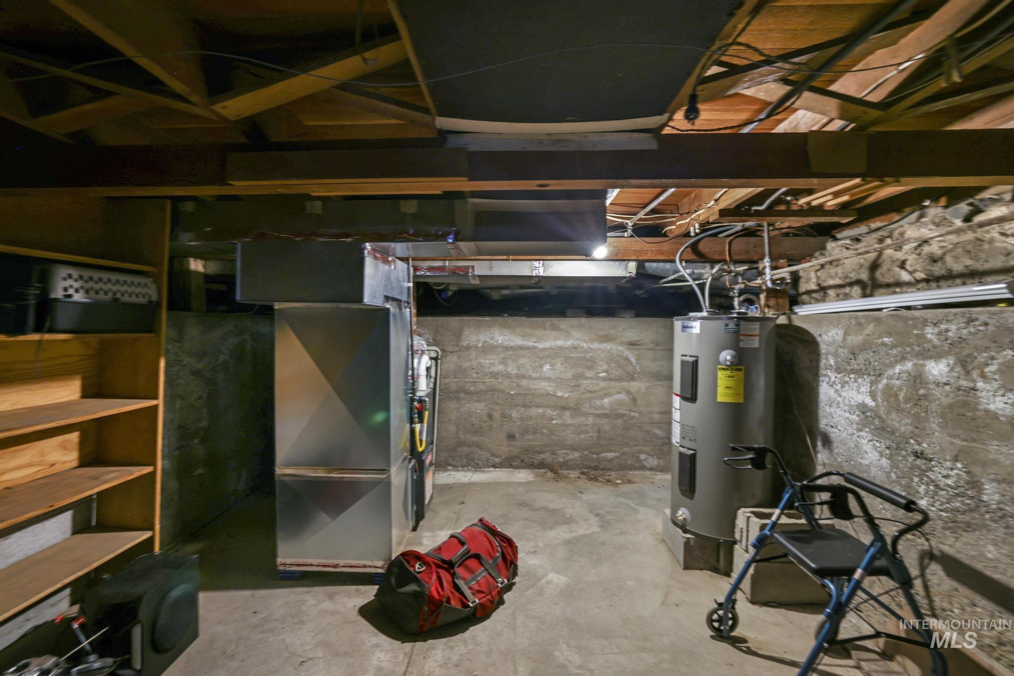 Unfinished below grade area with water heater and heating unit