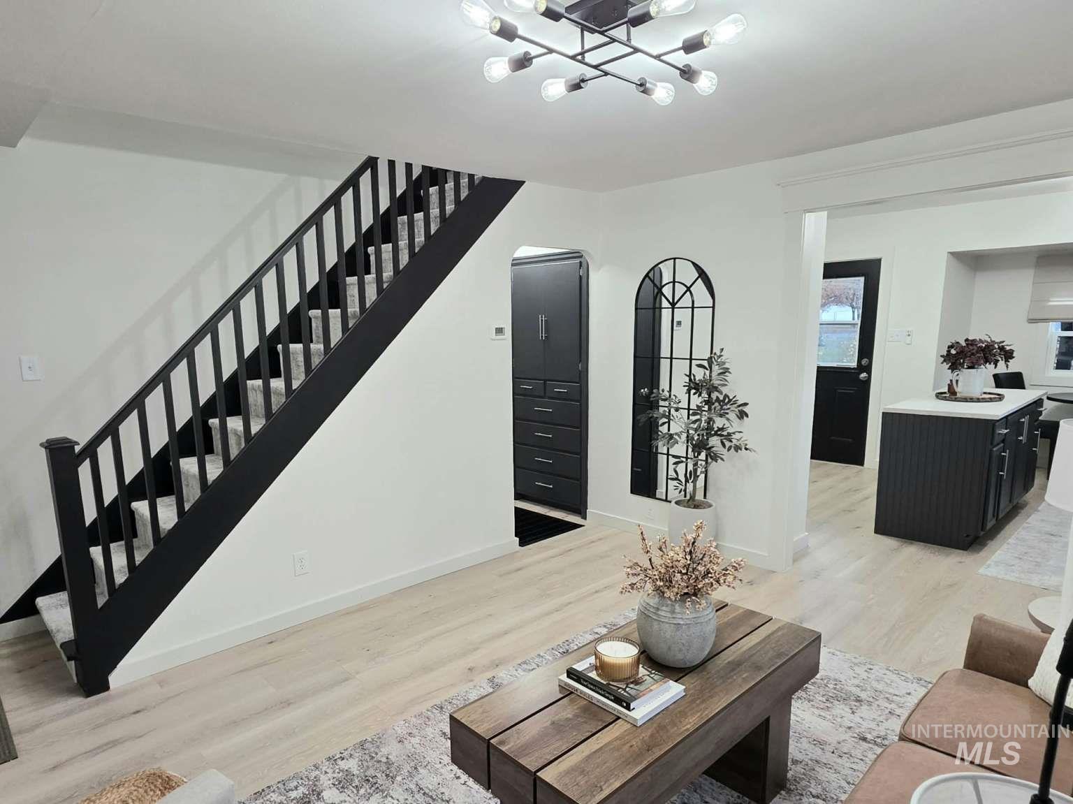 Living area featuring light wood-style floors and stairs