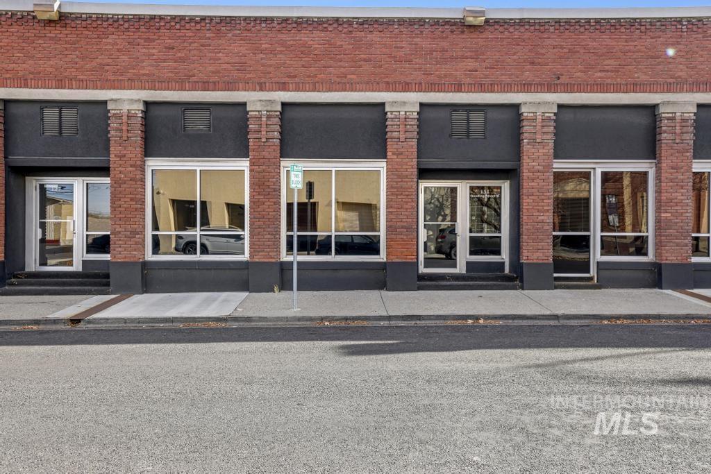 View of exterior entry featuring brick siding