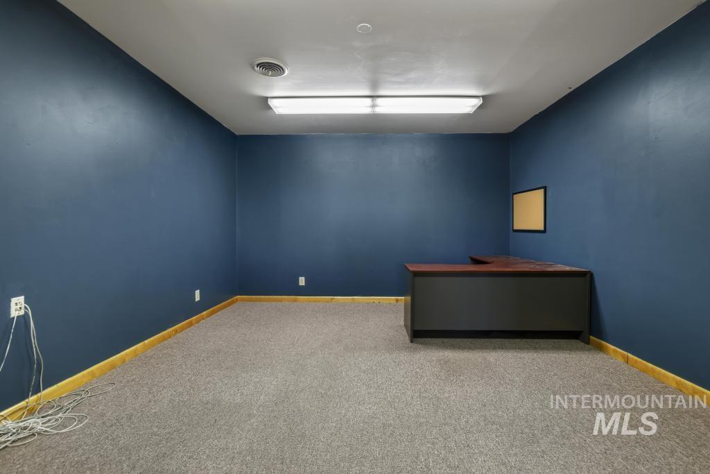 Unfurnished office with carpet and baseboards