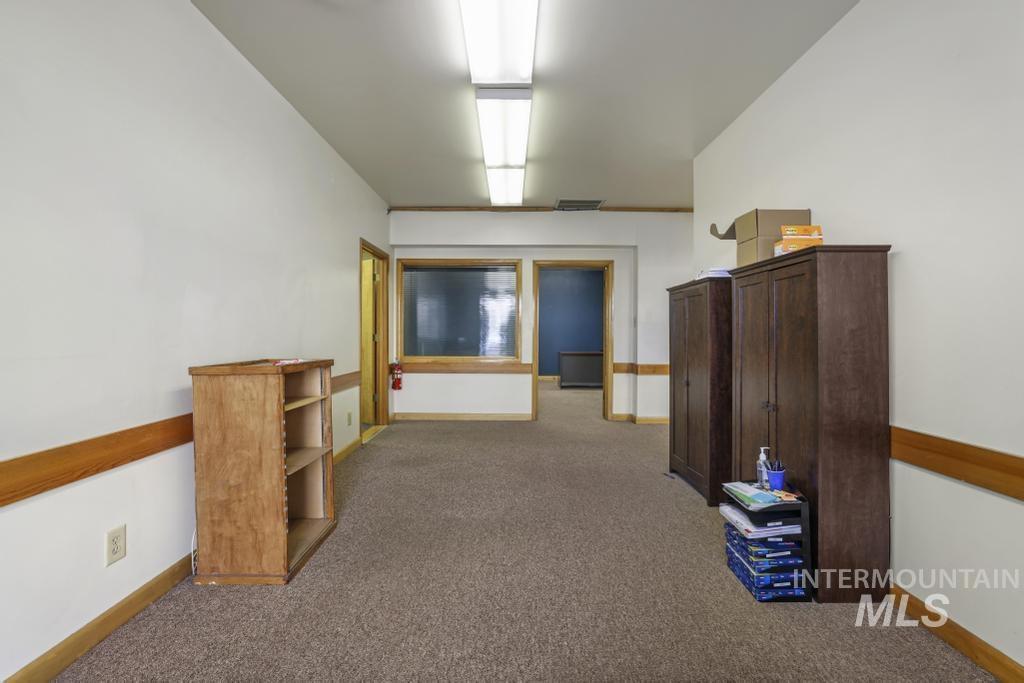 Hallway with dark colored carpet