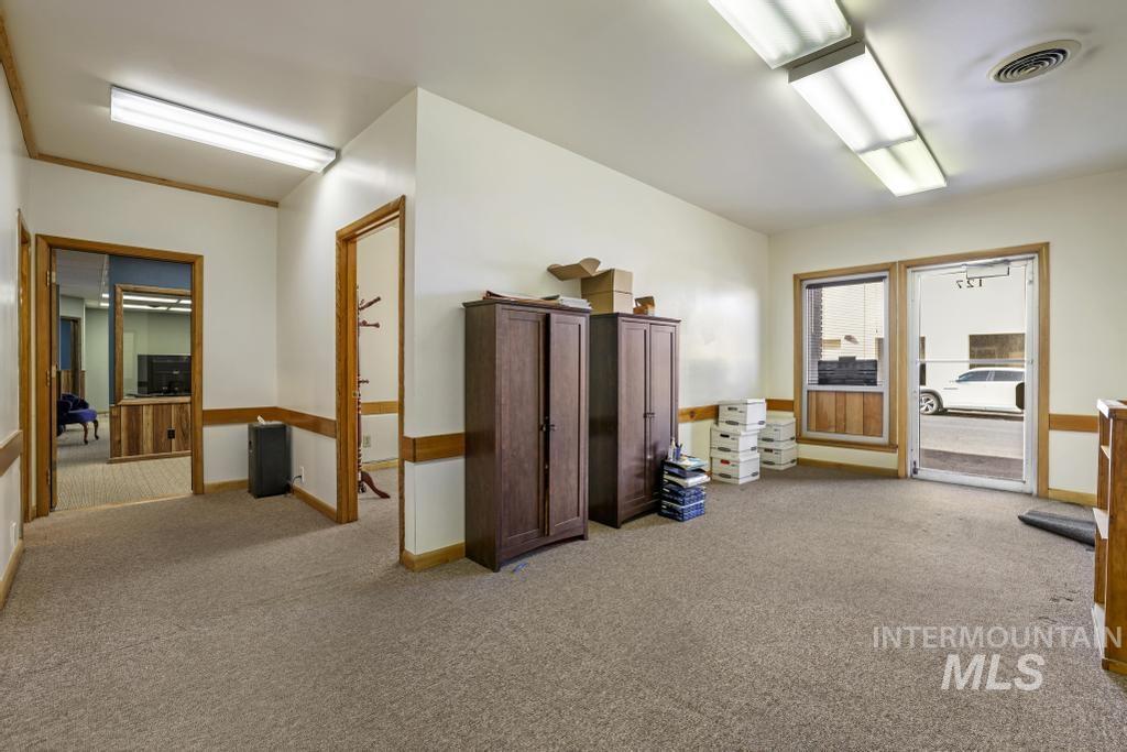 Hall with light carpet and baseboards