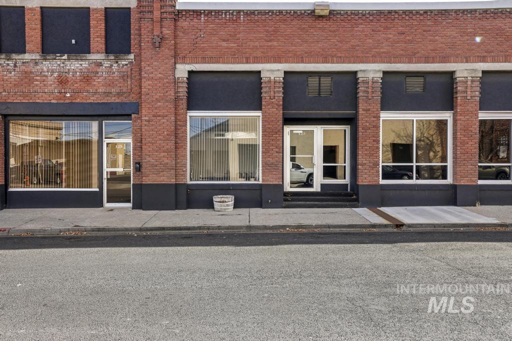Entrance to property featuring brick siding