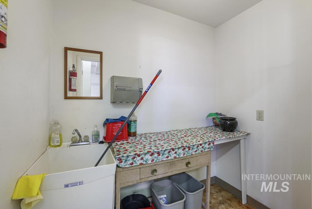 Laundry area featuring a sink and baseboards