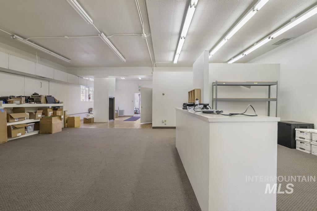 Kitchen featuring white cabinetry, light countertops, and open floor plan