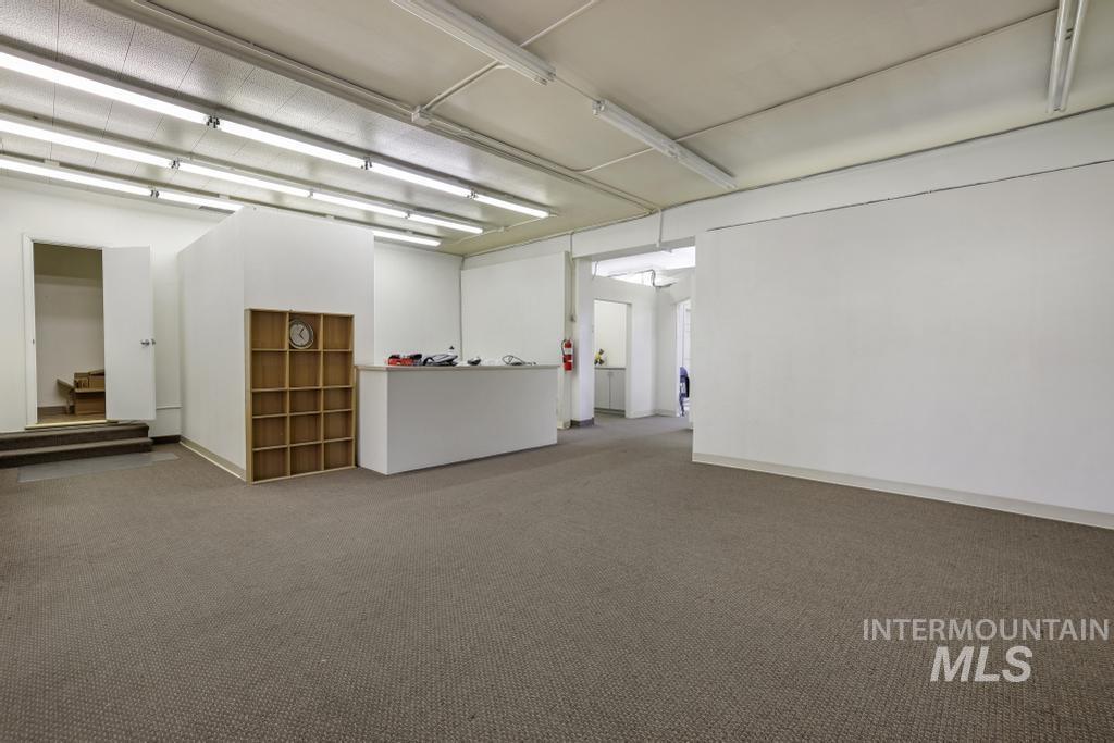 Spare room featuring carpet and baseboards