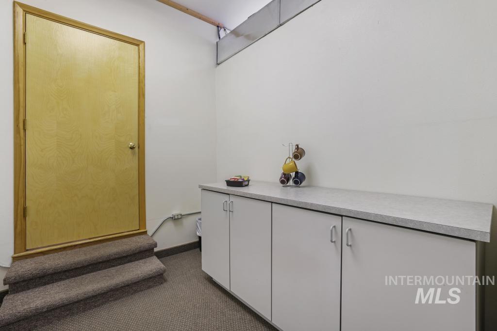 Interior space featuring carpet floors and baseboards