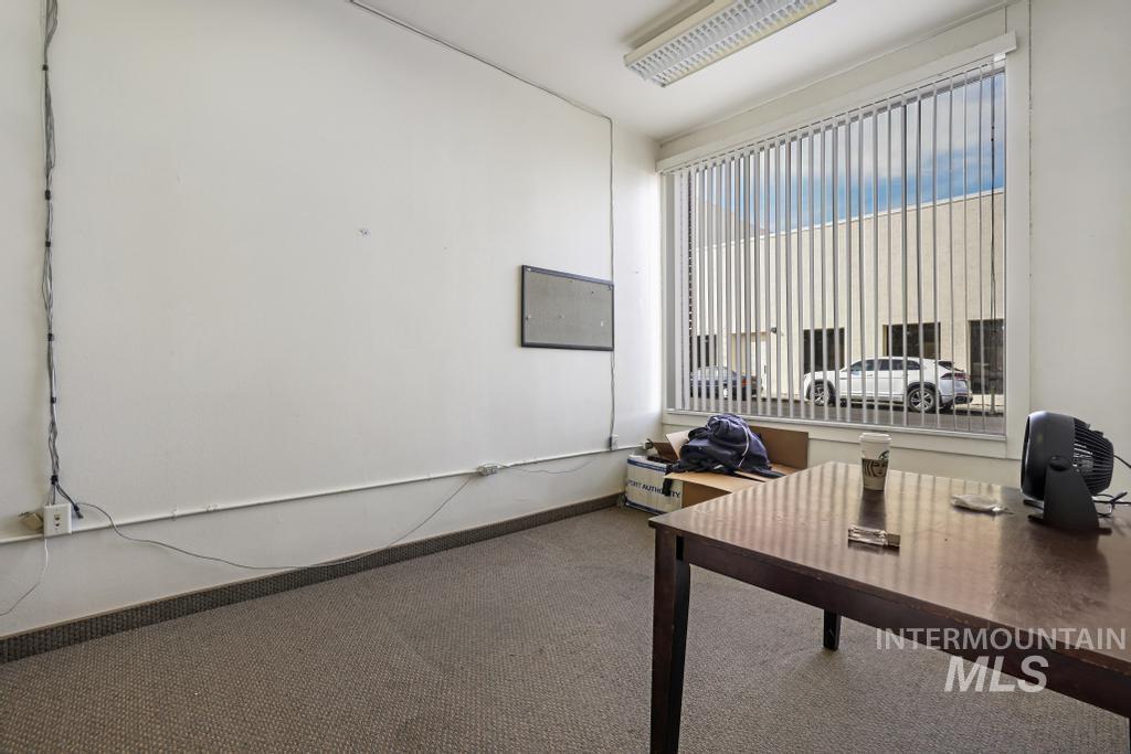 Carpeted office with baseboards