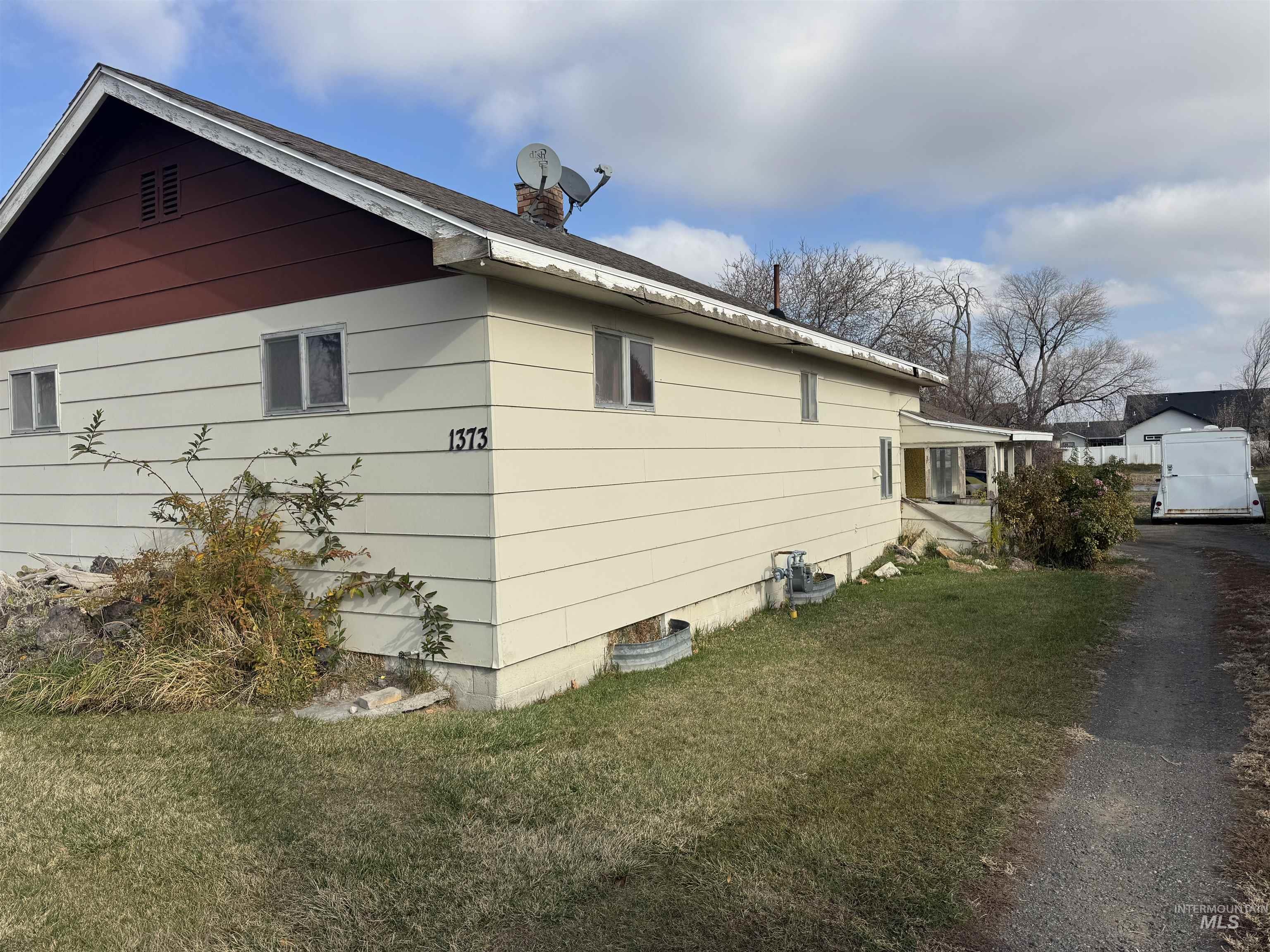 View of property exterior with a lawn