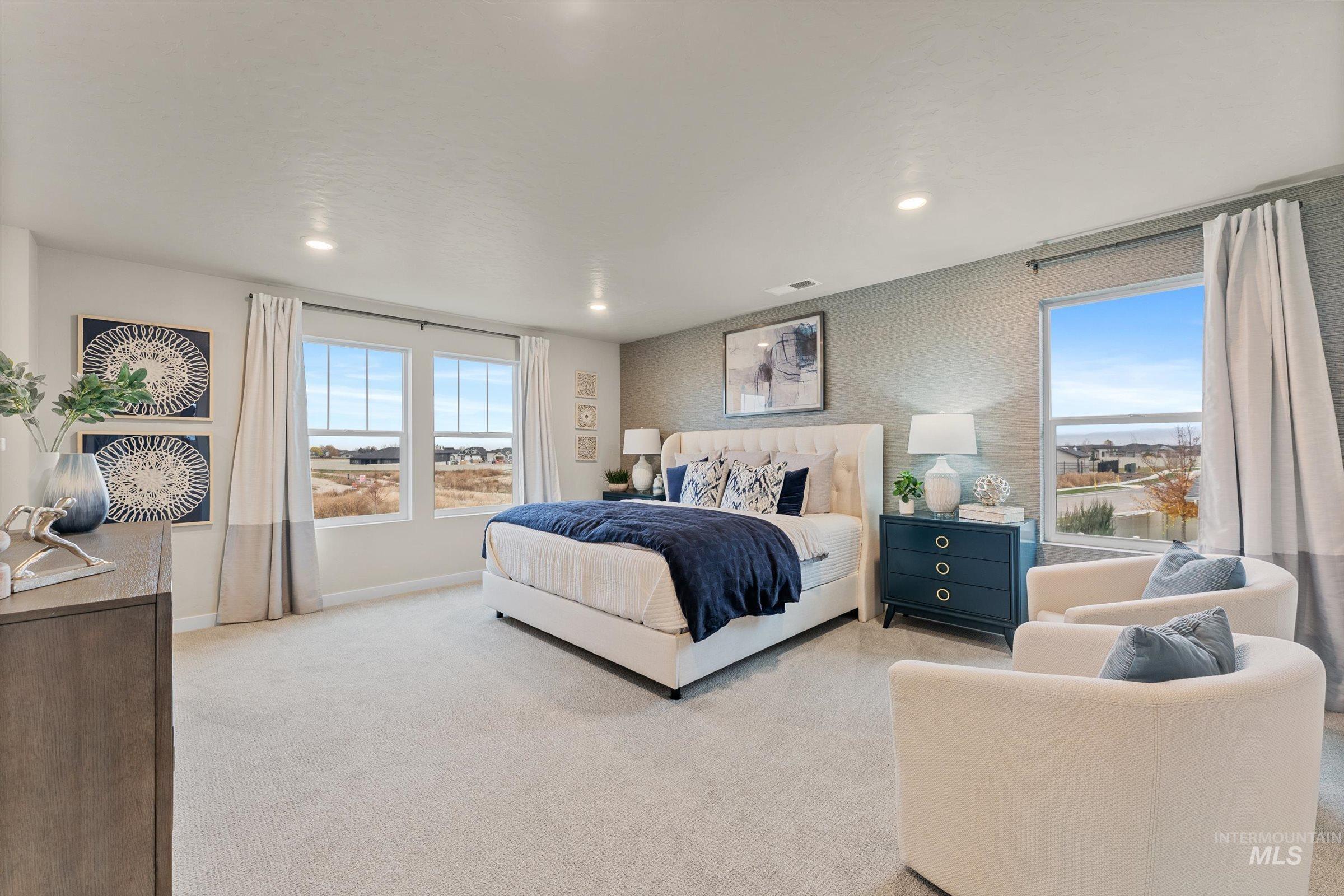 Bedroom with light carpet, multiple windows, wallpapered walls, and recessed lighting