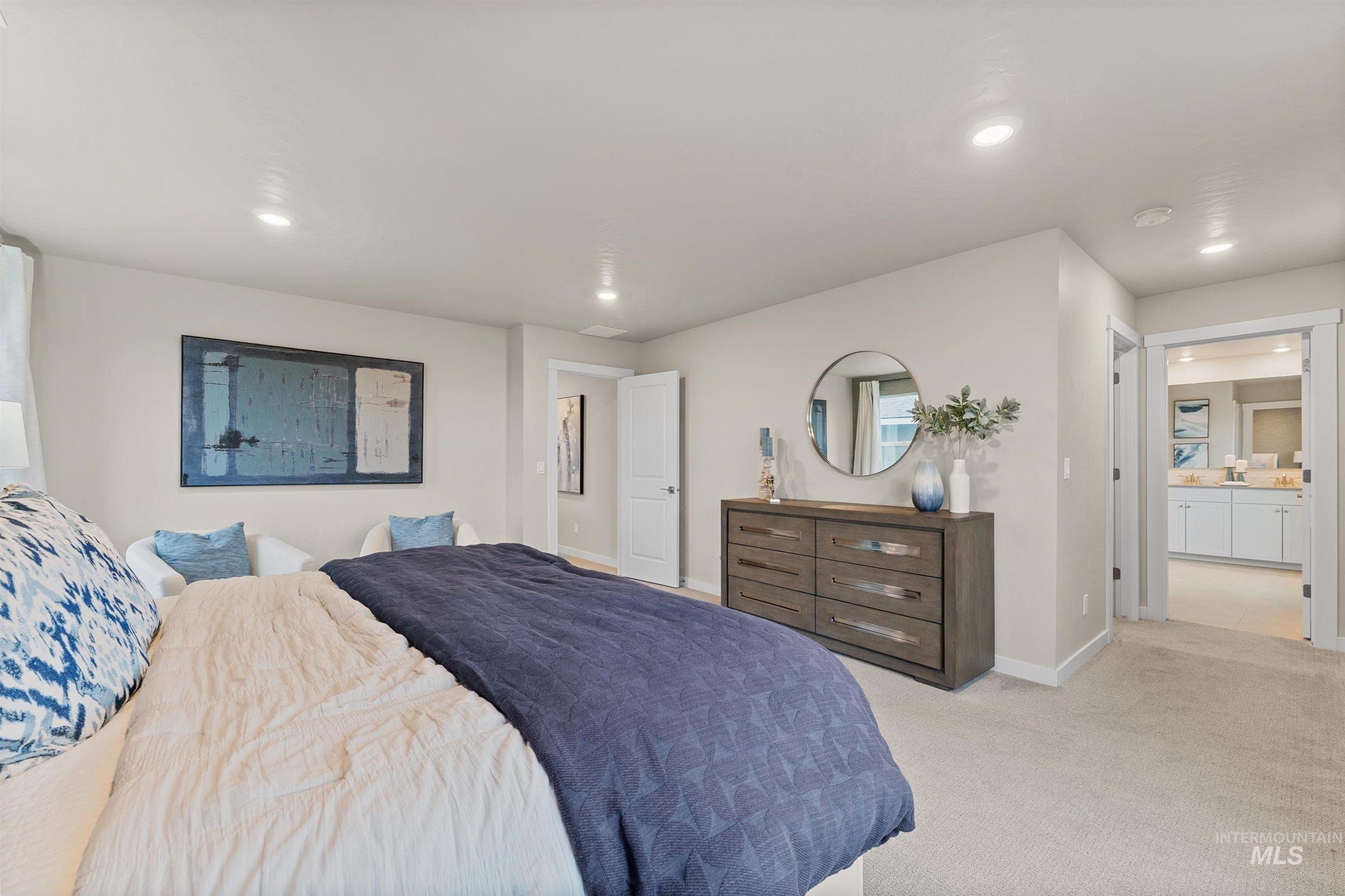 Bedroom with light carpet, recessed lighting, and ensuite bath