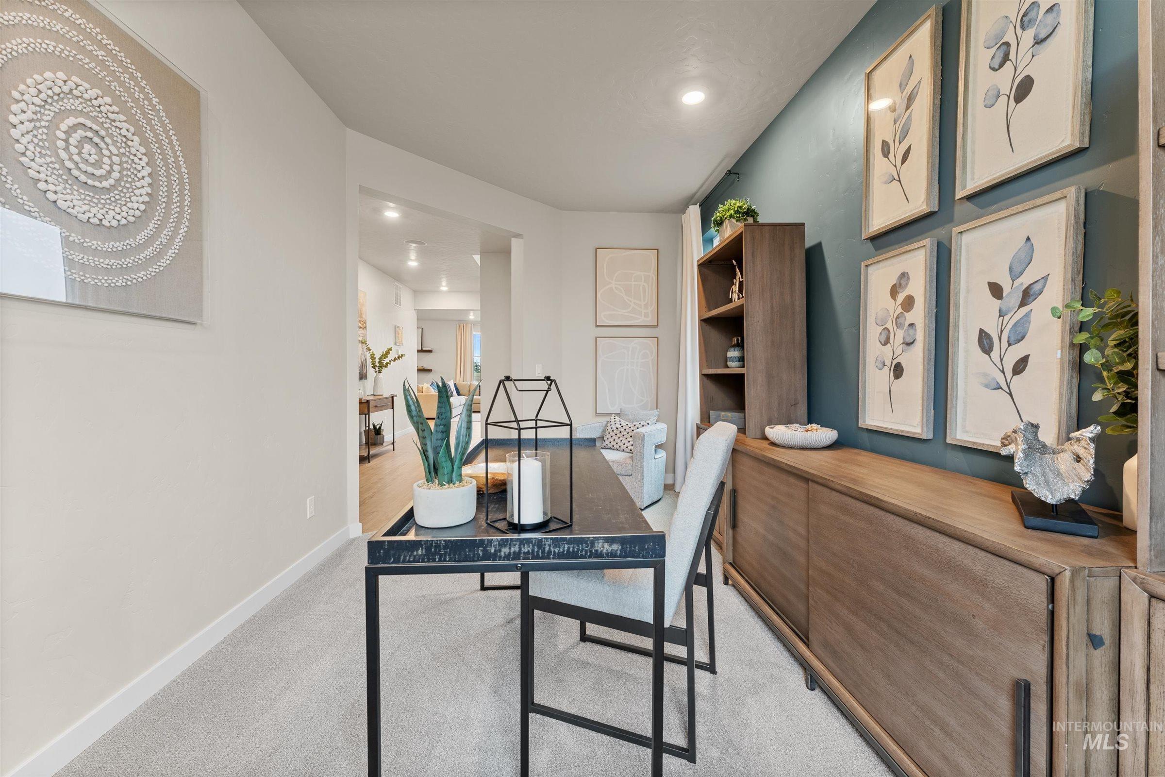 Office area with light carpet and recessed lighting