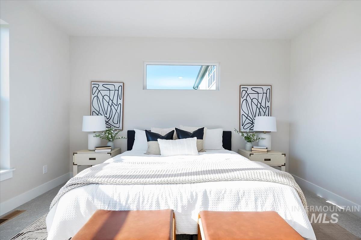 Carpeted bedroom featuring baseboards