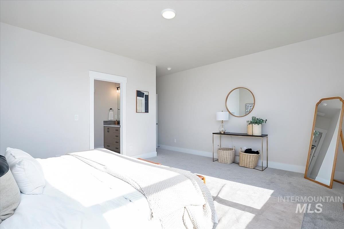 Bedroom with carpet flooring and ensuite bath
