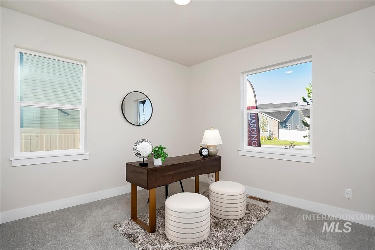 Carpeted office space featuring baseboards