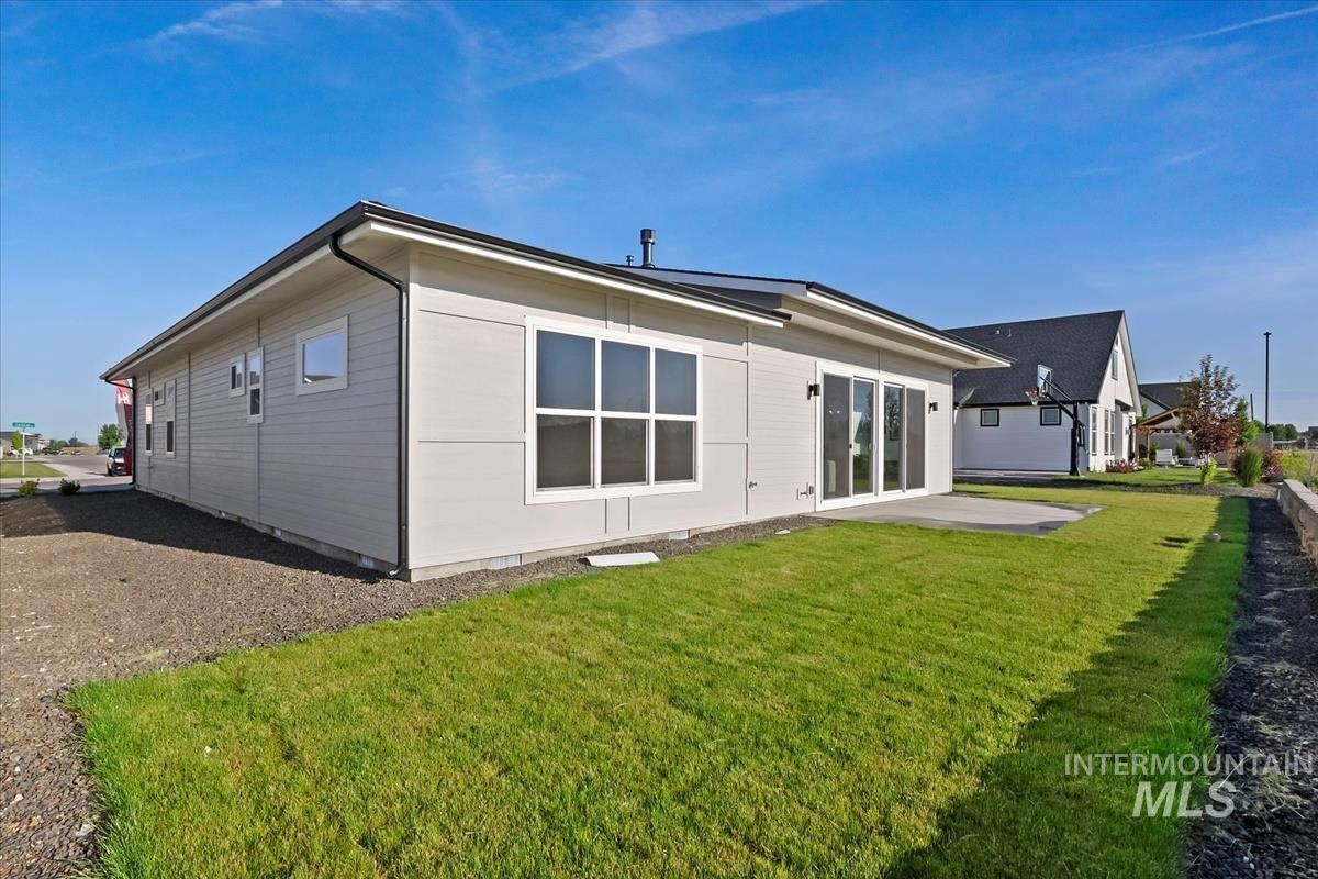 Back of house with a patio area and a yard