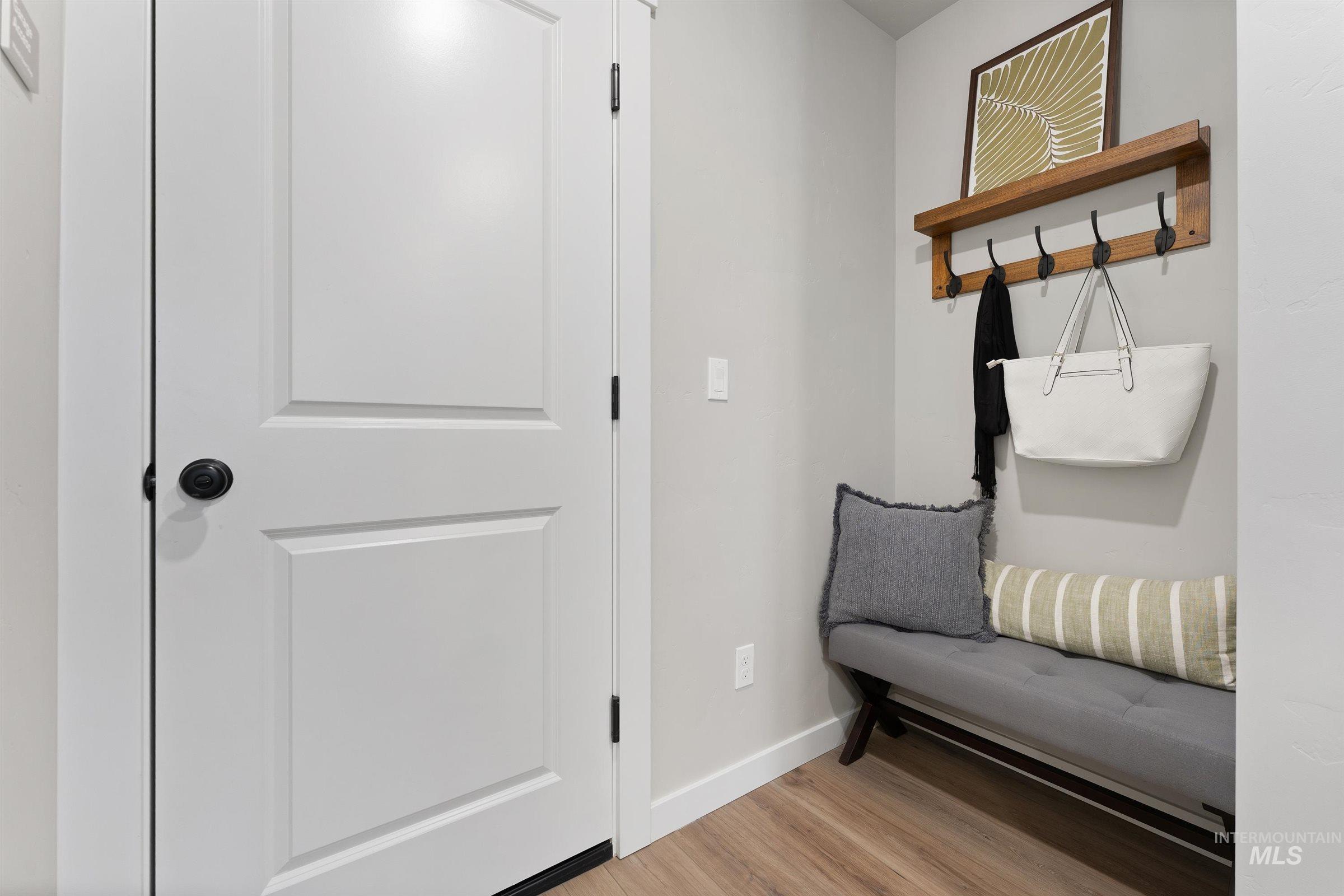Living area featuring baseboards and light wood-style flooring