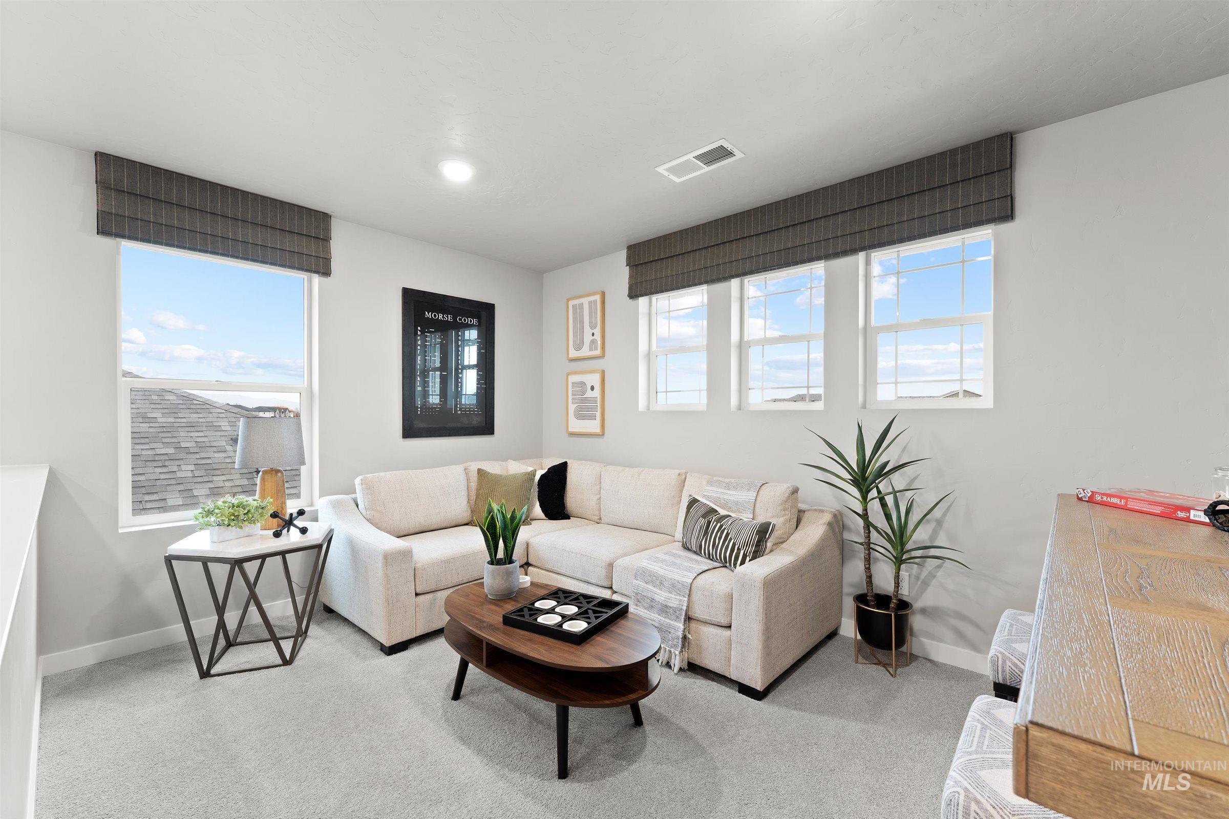 Carpeted living room with baseboards
