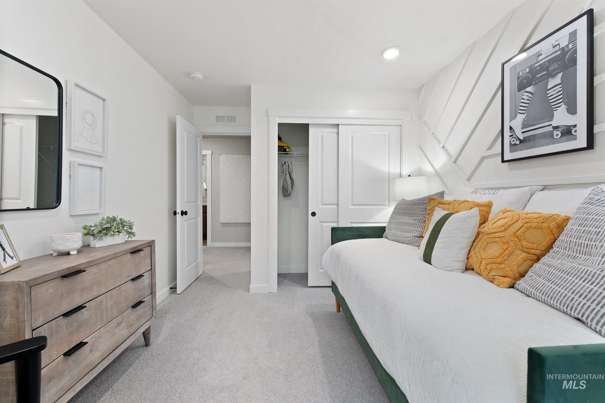 Bedroom featuring light colored carpet, a closet, and recessed lighting