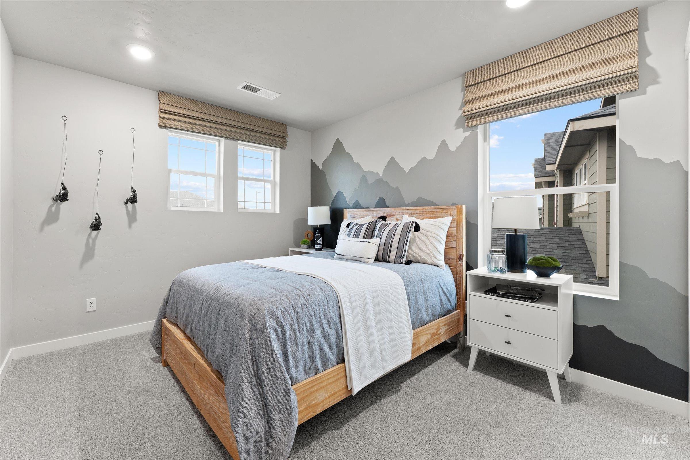 Carpeted bedroom featuring multiple windows and recessed lighting
