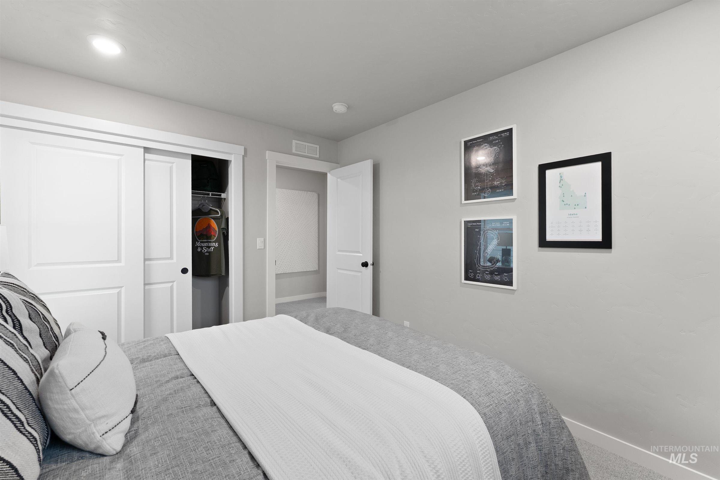 Carpeted bedroom with baseboards and a closet