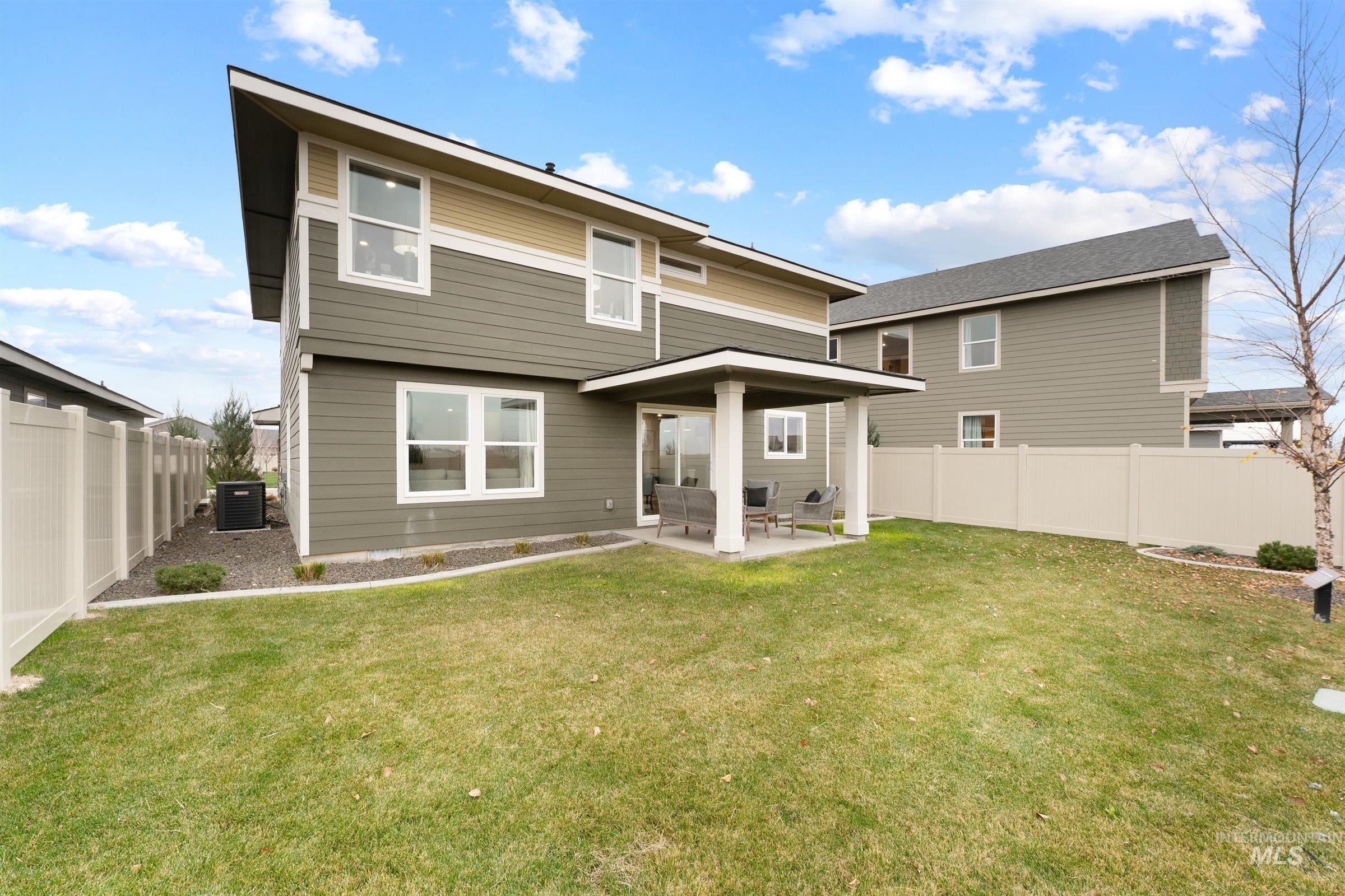 Back of property with a patio and a fenced backyard