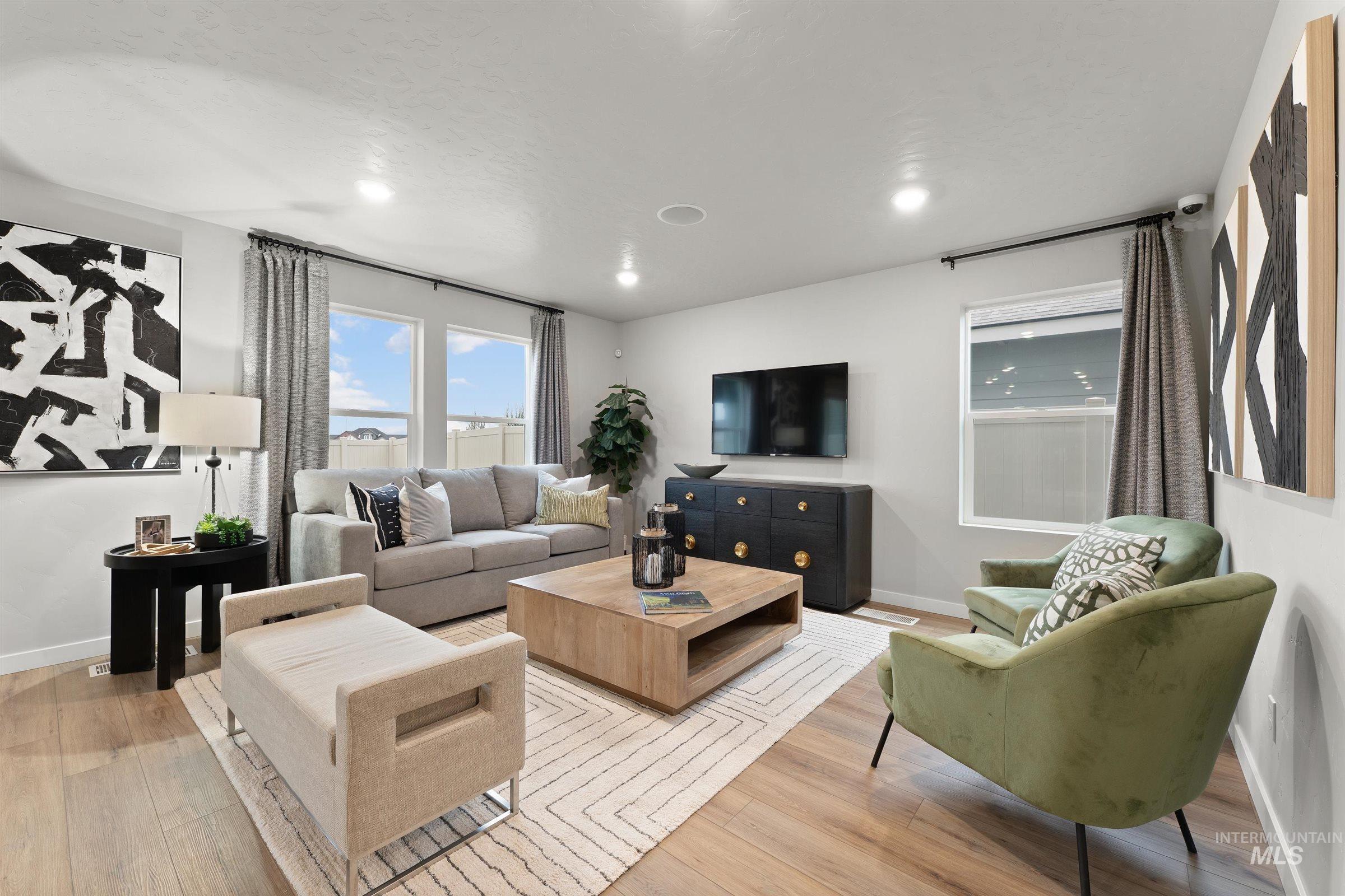 Living area with light wood-style floors and recessed lighting