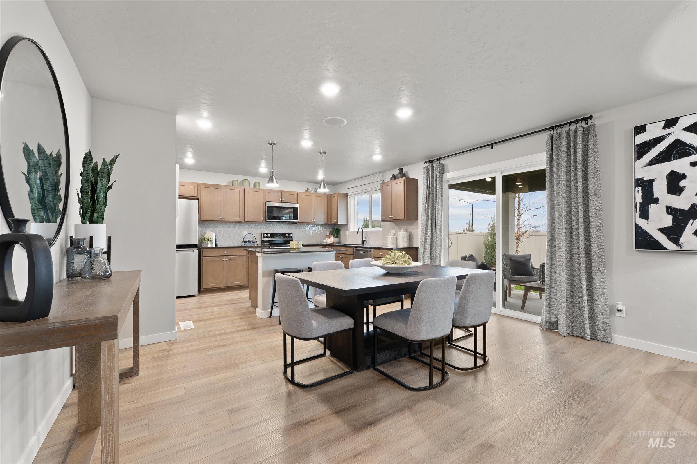 Dining area featuring light wood finished floors and recessed lighting