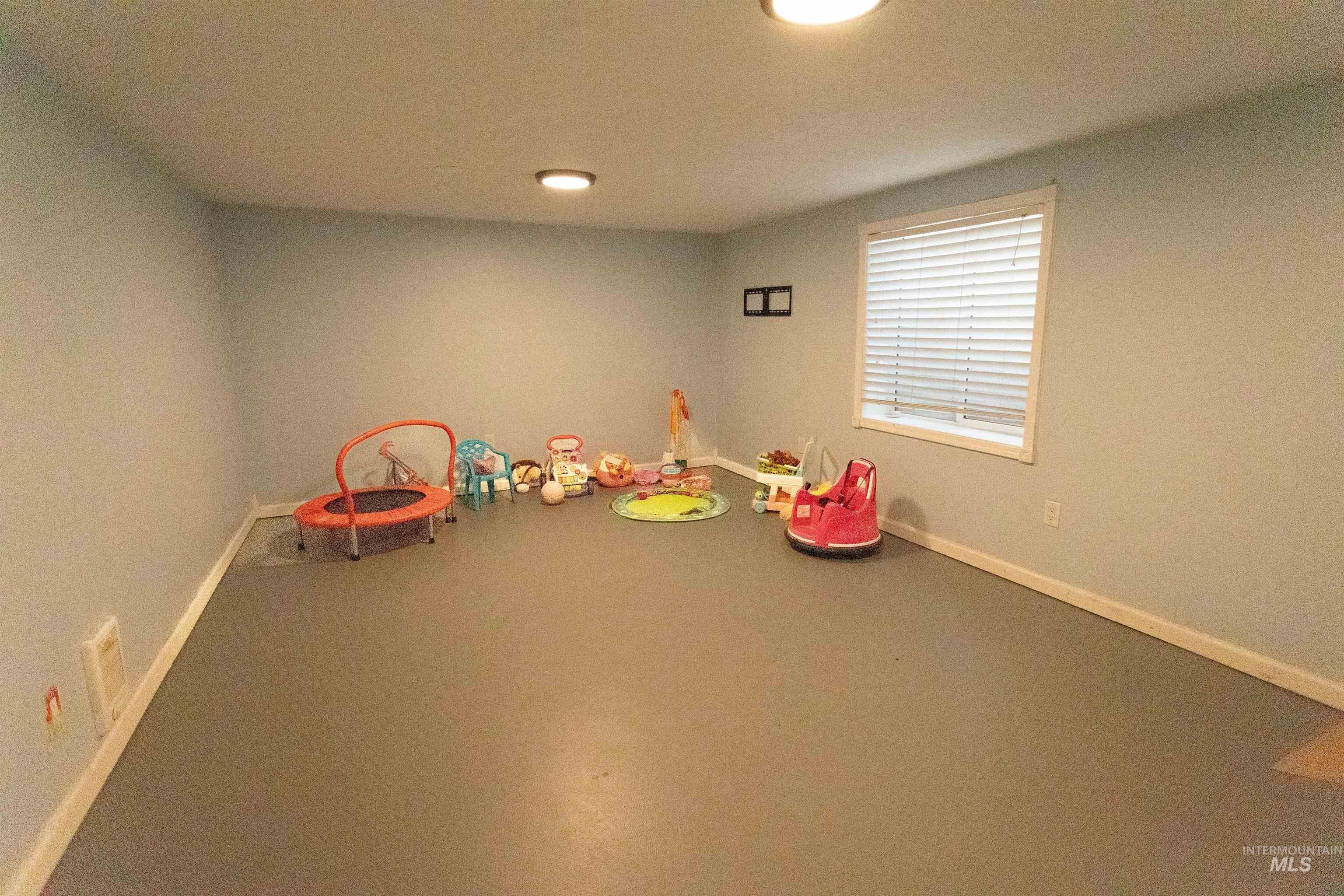 Recreation room featuring baseboards and recessed lighting