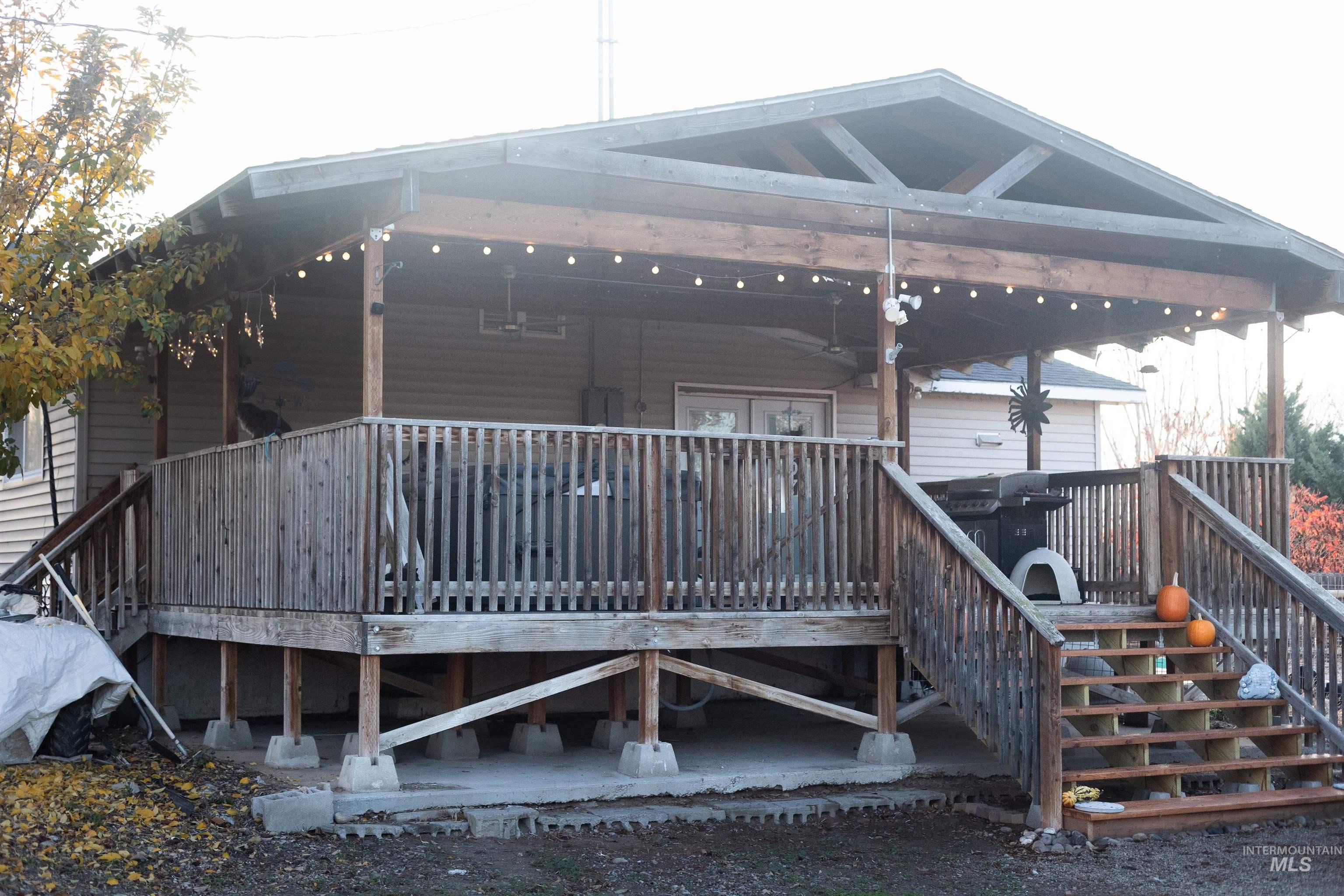 Back of property featuring a wooden deck and stairway