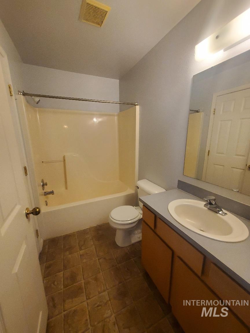 Bathroom with vanity and shower / bath combination