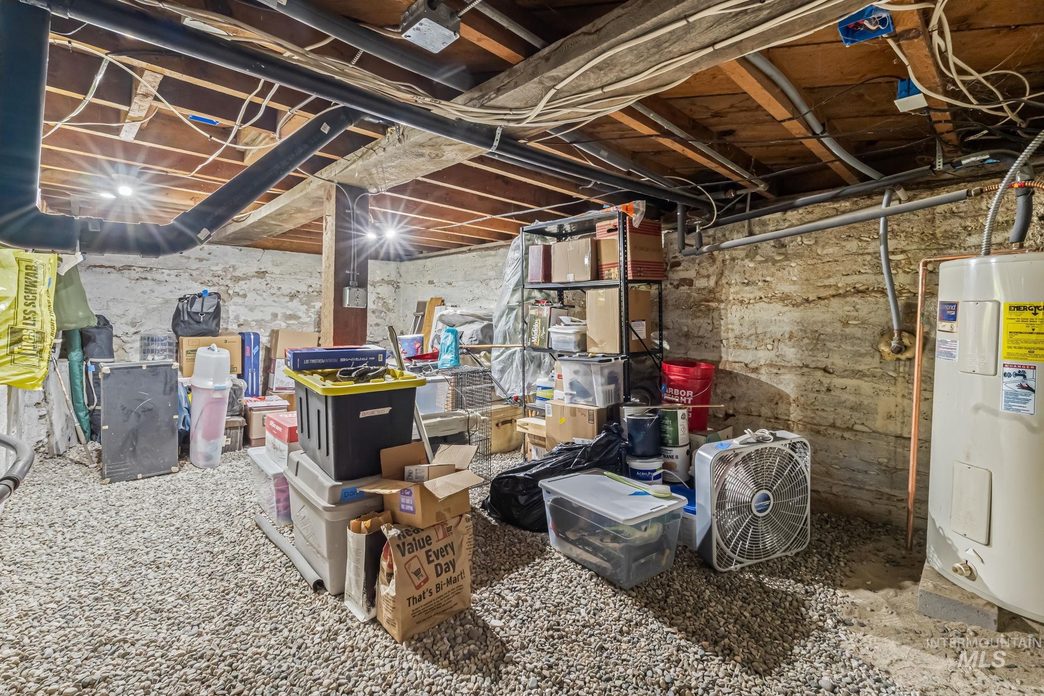 Unfinished basement featuring electric water heater