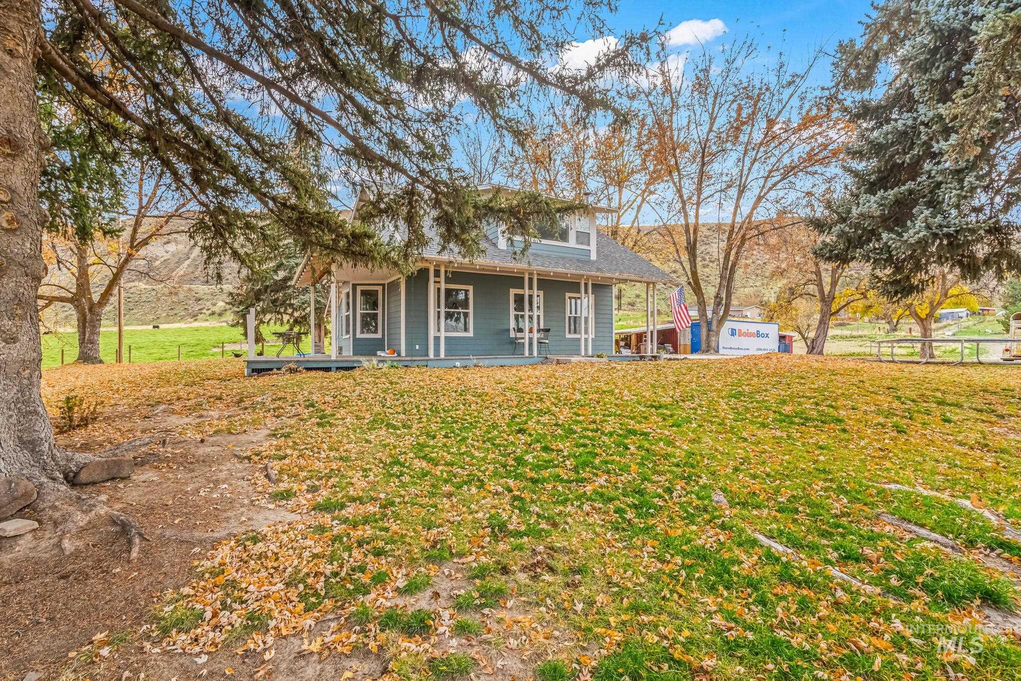 View of front of home featuring a porch, a front lawn, and a shingled roof