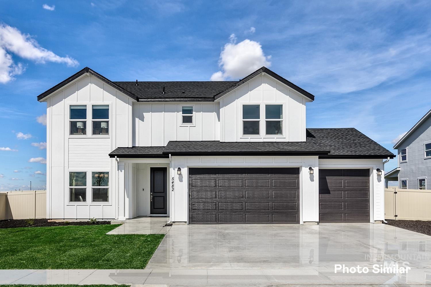 Modern farmhouse featuring roof with shingles, board and batten siding, driveway, and an attached garage