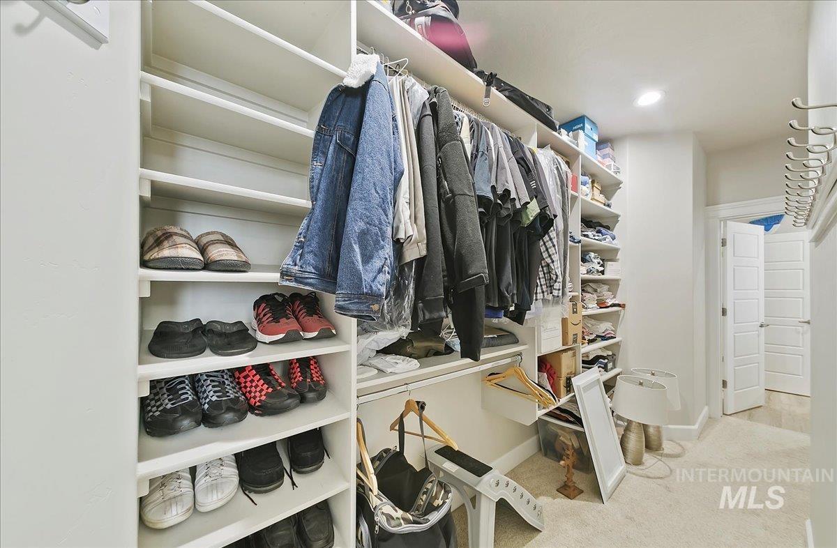 Spacious closet with carpet floors