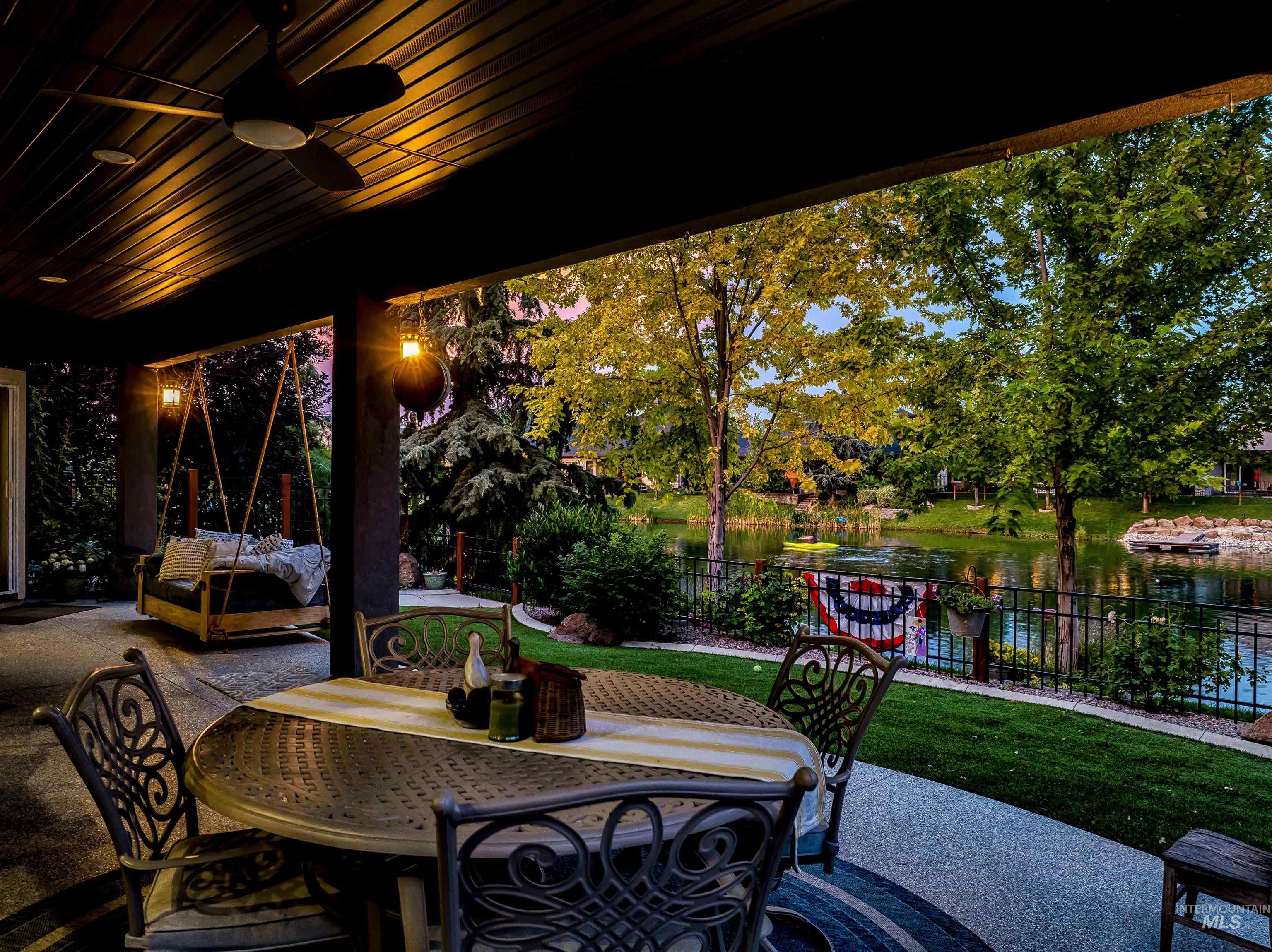 View of patio / terrace with a ceiling fan, a water view, and outdoor dining area