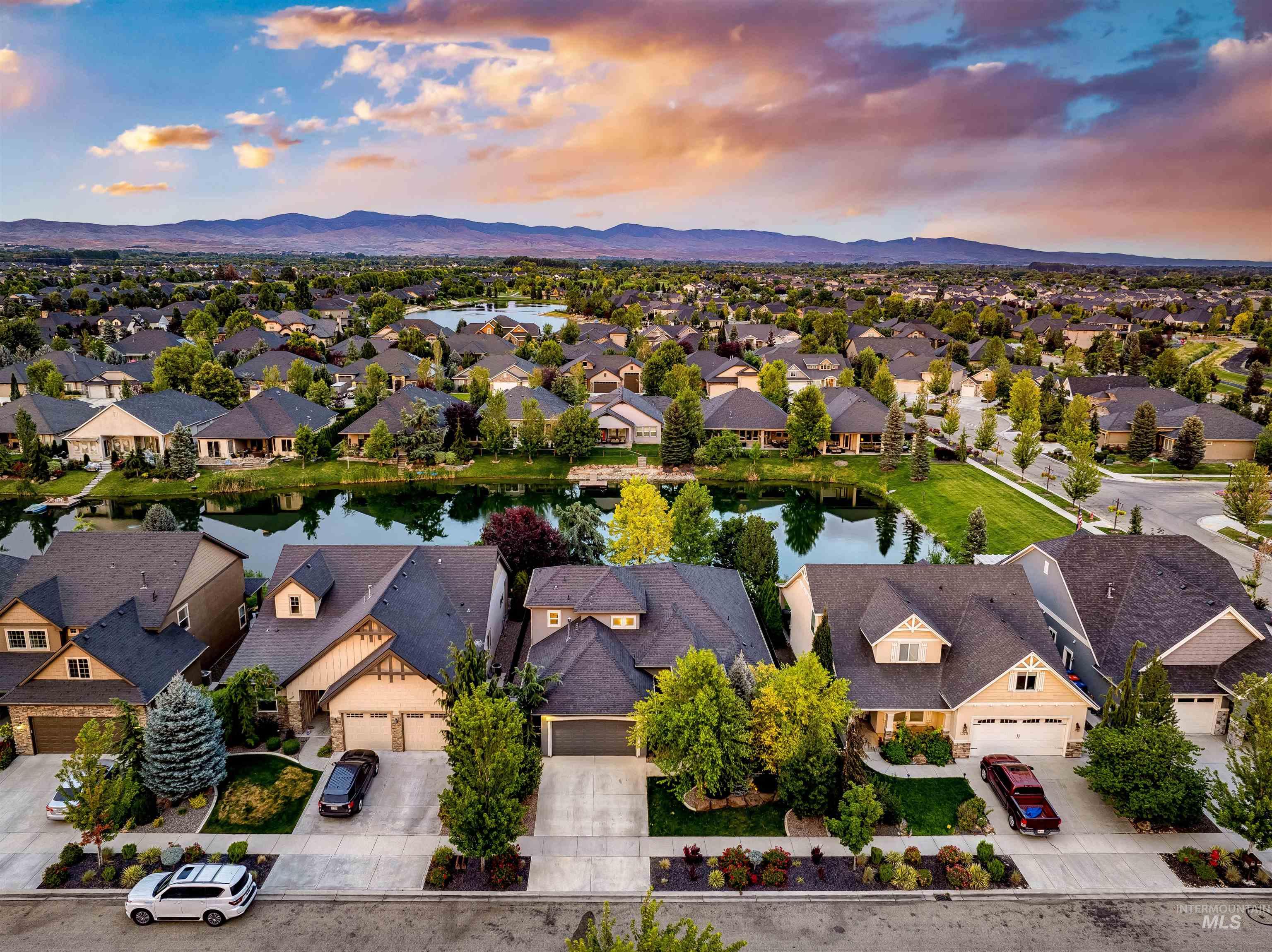 Aerial view at dusk of a water and mountain view and a residential view
