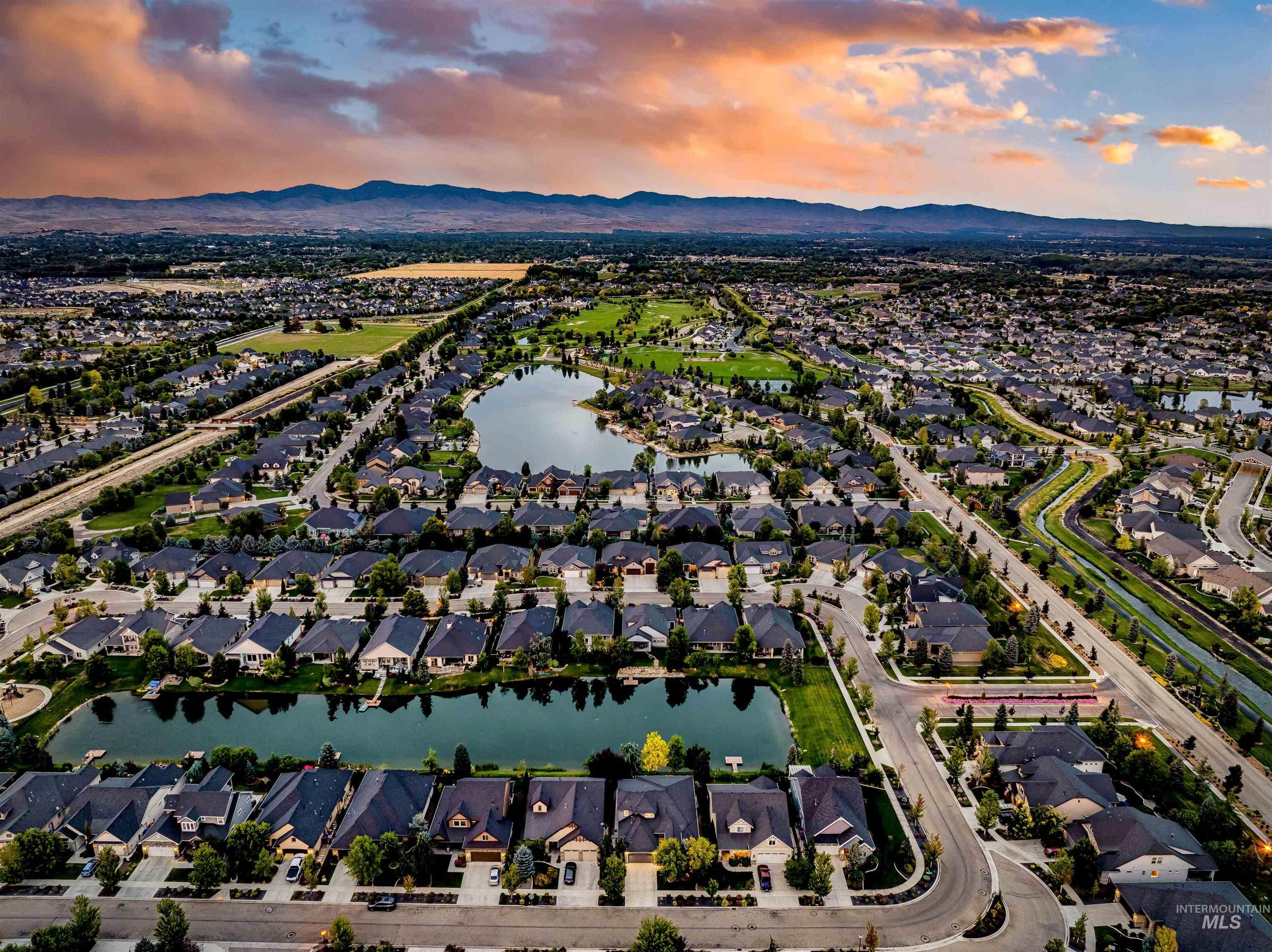 Aerial view at dusk of a residential view and a water and mountain view